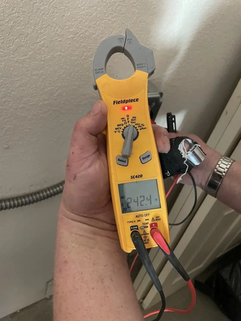 Voltage testing with clamp meter during Recessed Lighting Installation in Mableton